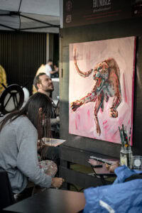 Artist Humble paints during Live Art for Charity. Photo by Nina Violi.